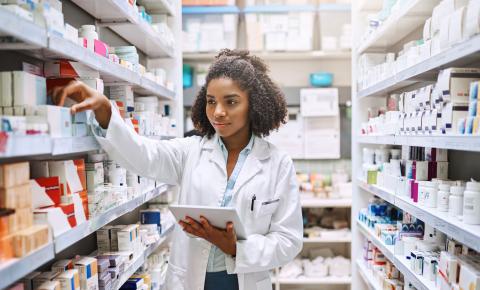 Pharmacy assistant checks inventory at a pharmacy.