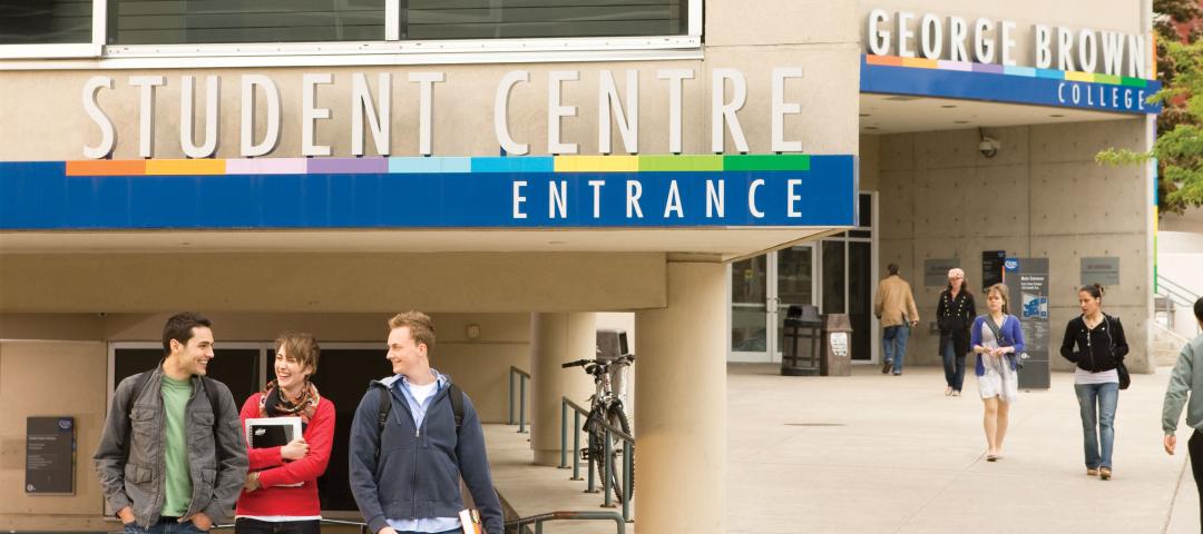 Students stand in front of a Student Service Centre.
