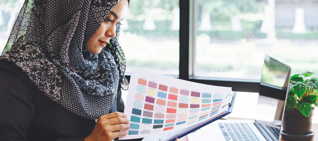 Designer reviews the palette of a colour swatch while at work.