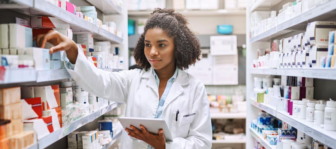 Pharmacy assistant checks inventory at a pharmacy.