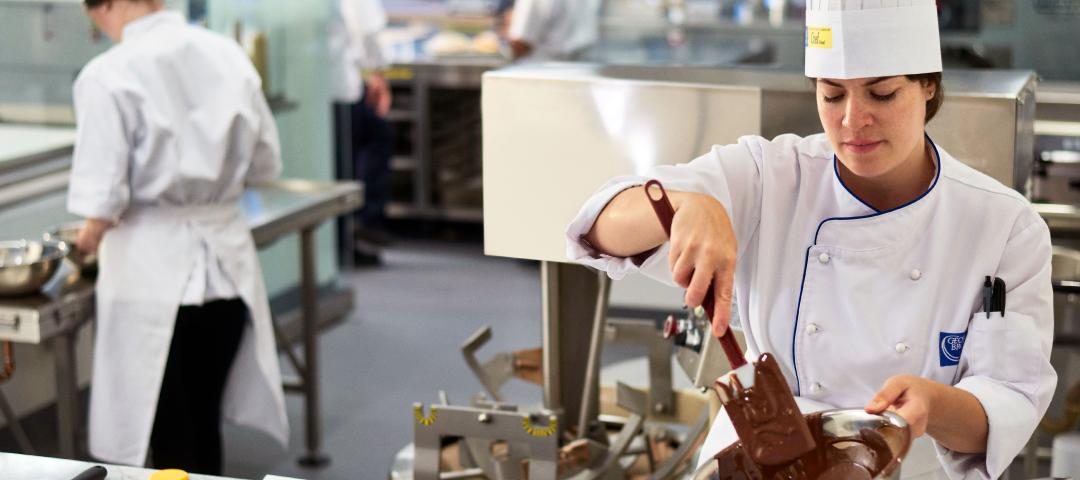 Baking arts students working with chocolate in a culinary lab.