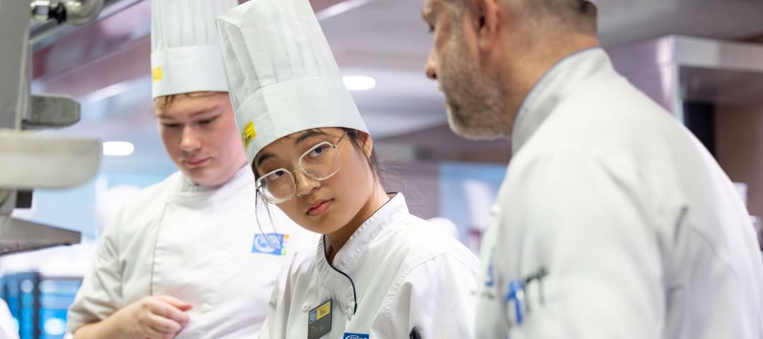 Culinary arts students get prepartion tips from their instructor as they cook in the state-of-the-art labs.